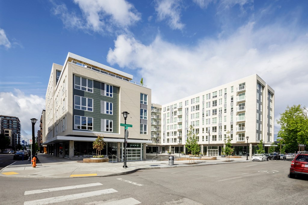 a view of an apartment buildings on the corner of a city street