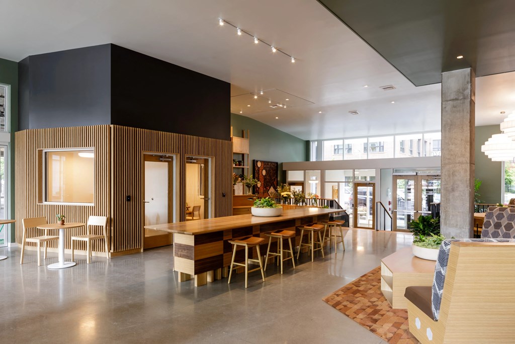 the lobby of a building with a large table and chairs