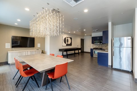 A modern dining room with a large table and chairs.