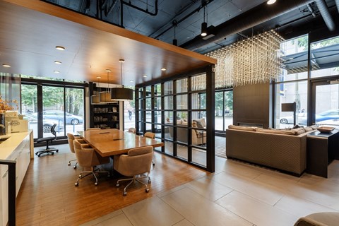 A modern living room with a dining table and chairs.