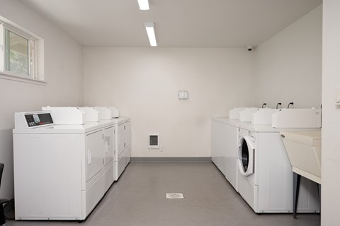 A laundry room with washers and dryers.