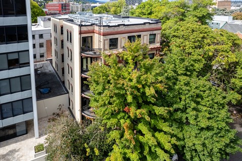 an aerial view of an apartment building with trees