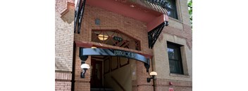 the front of a brick building with an entrance sign