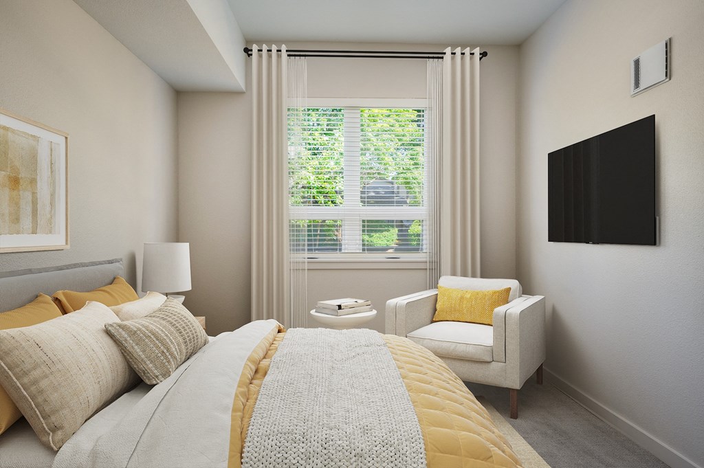 a bedroom with a bed and a chair and a window