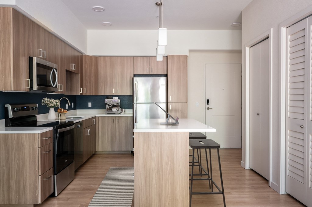 a kitchen with wooden cabinets and a white counter top