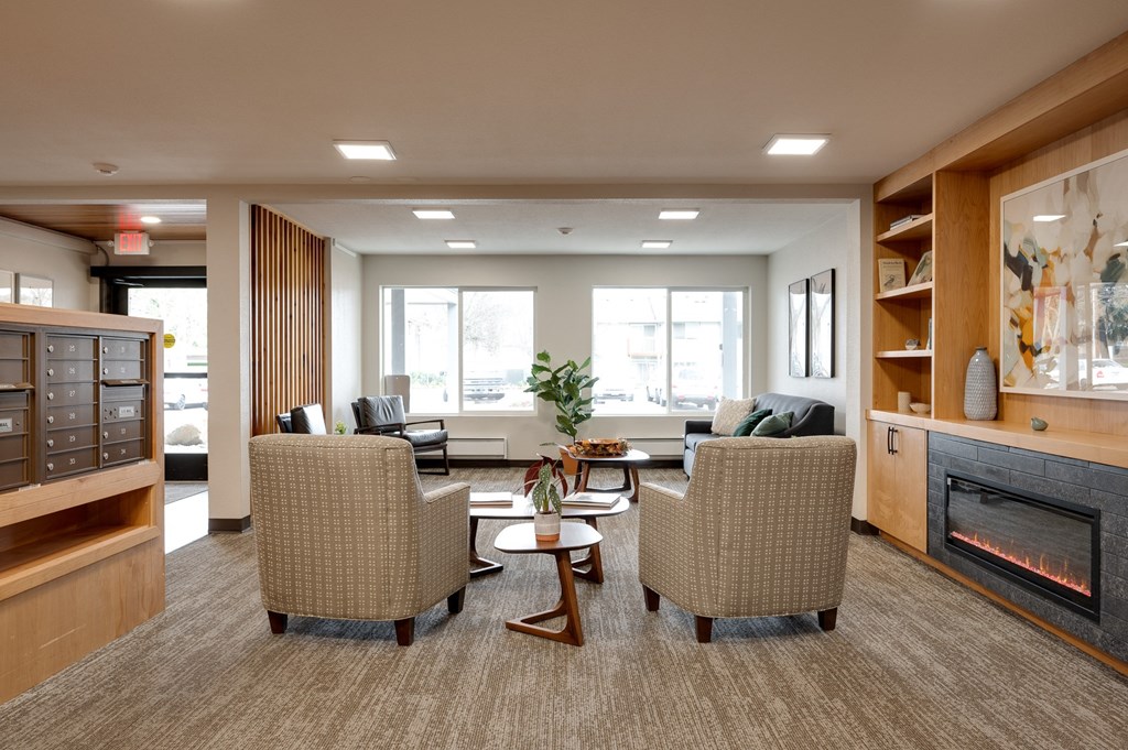 a living room with couches and chairs and a fireplace