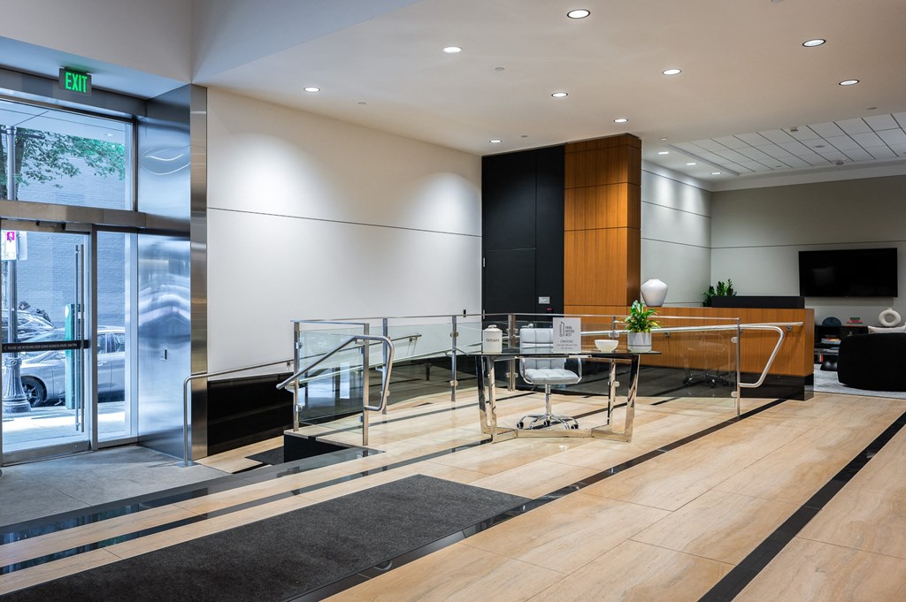a conference room with a glass table and chairs and a large window