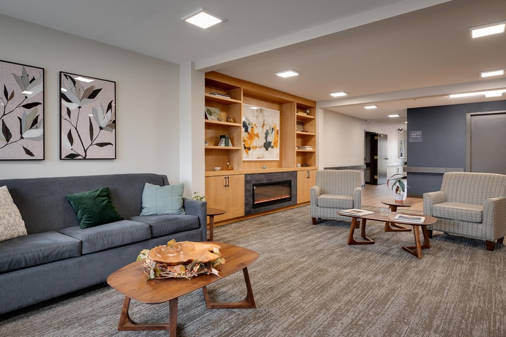 a living room with couches and chairs and a fireplace