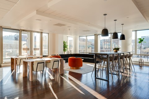 A modern dining room with a long table and chairs.