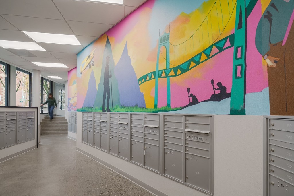 a mural of the brooklyn bridge is painted on the wall of a school hallway