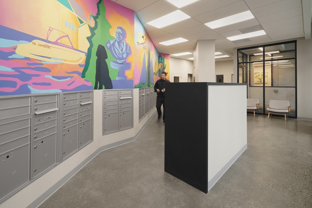 a mural of a boat and a man in a suit is painted on the wall of a