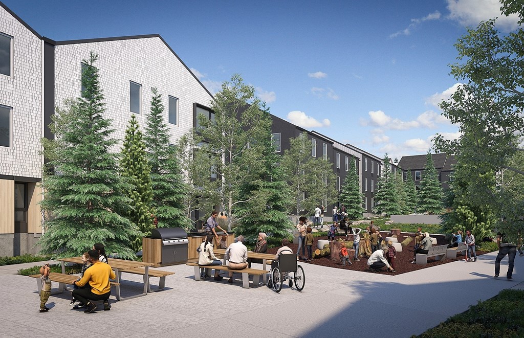 a group of people sitting at benches outside of a building