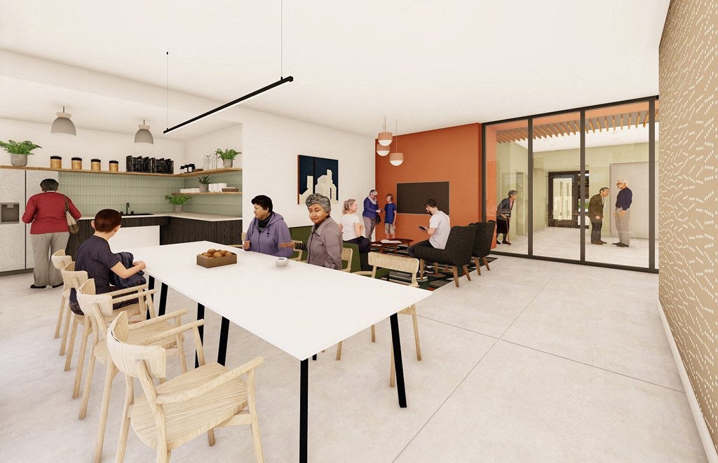 a group of people sitting around a white table in a room