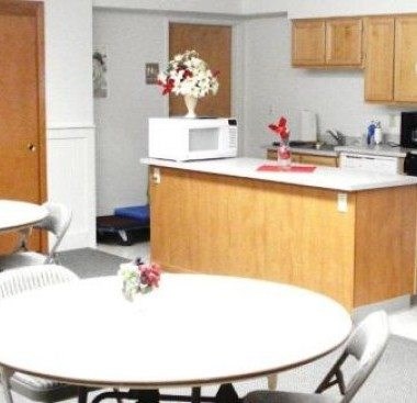 A kitchen with a white microwave on the counter.