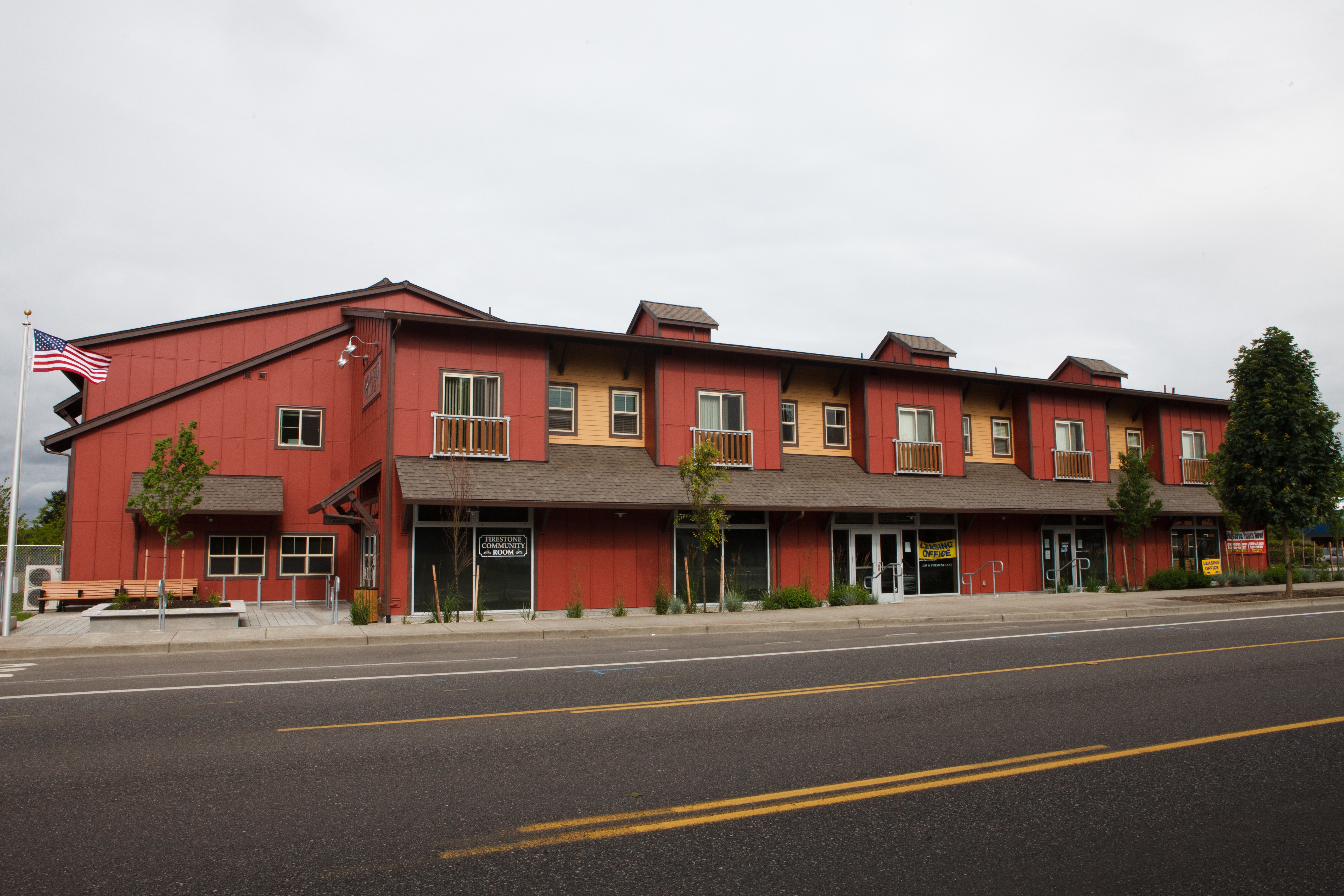 A red building with a flag on the left side.