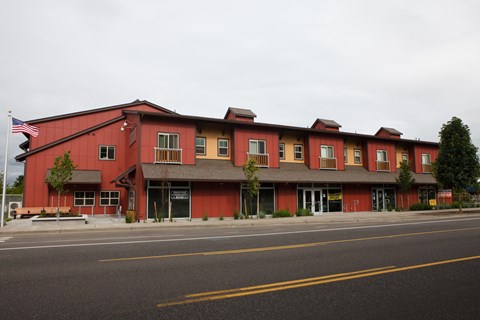 A red building with a flag on the left side.
