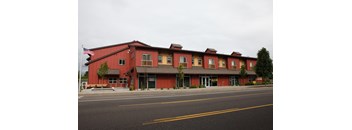 A red building with a flag on the left side.