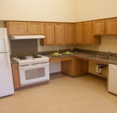 A kitchen with wooden cabinets and a white refrigerator.