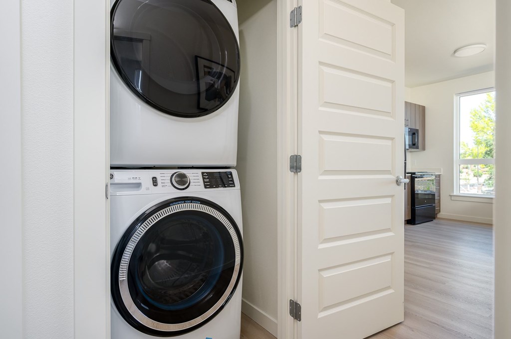A white washing machine and dryer in a laundry room.