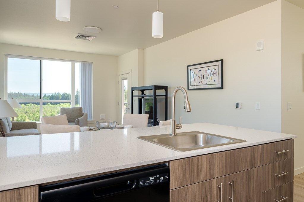 A modern kitchen with a large island and a dishwasher.