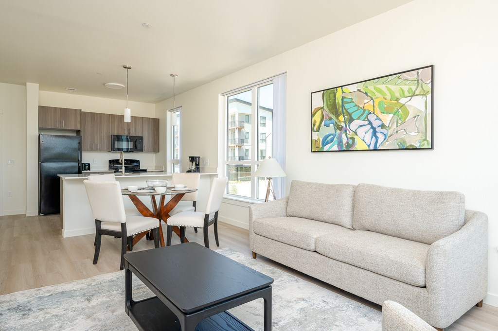 A modern living room with a dining table and a couch.