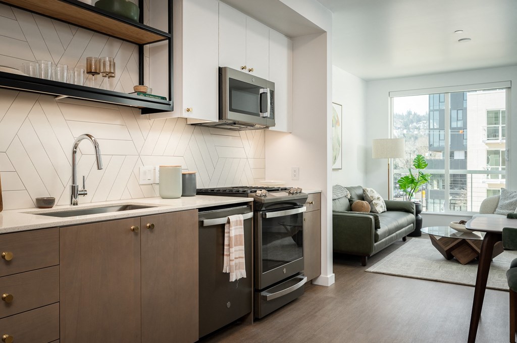 a kitchen with a sink and a stove and a microwave
