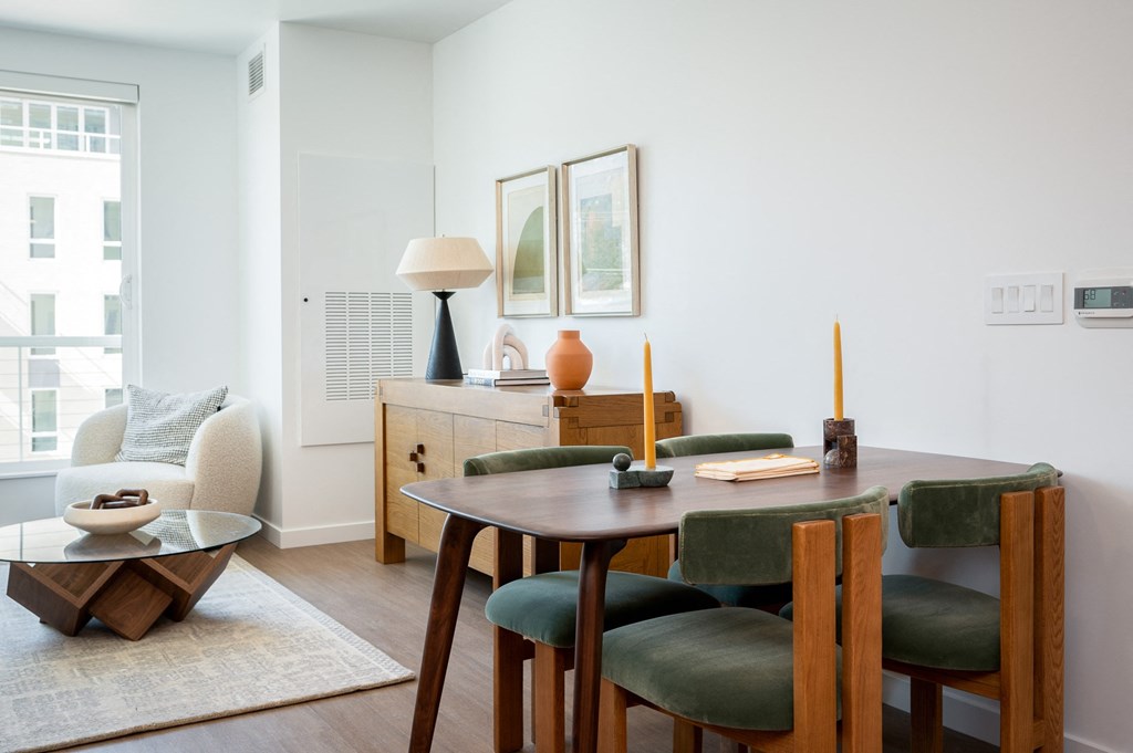 a dining room and living room with a table and chairs