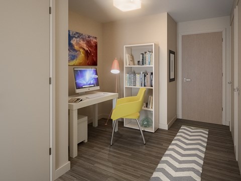 A room with a desk, chair, and bookshelf.