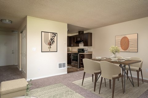 a dining room and kitchen with a table and chairs