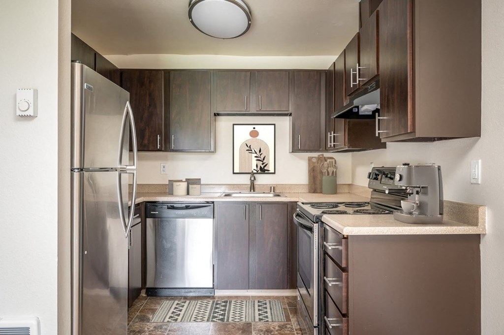 a kitchen with stainless steel appliances and wooden cabinets