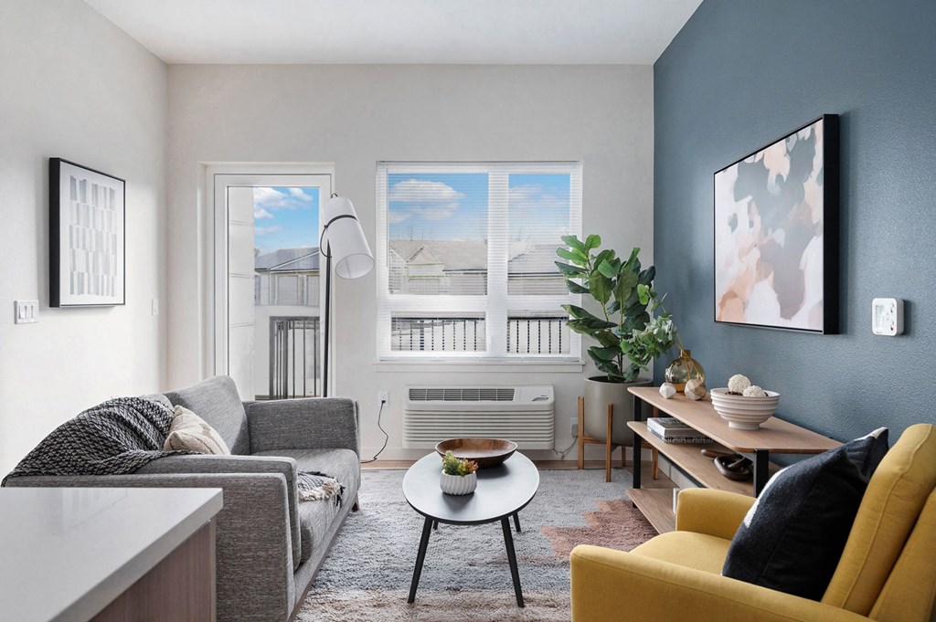 a living room with blue walls and a large window