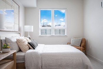 a bedroom with a large bed and a window - Photo Gallery 19