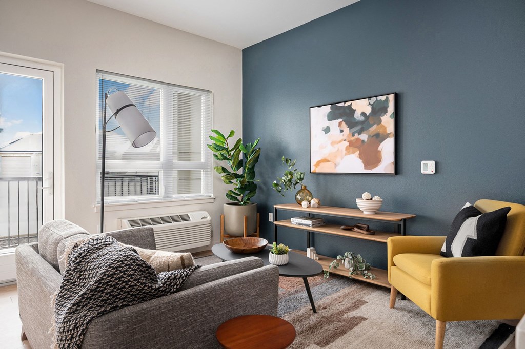 a living room with two couches and a yellow chair
