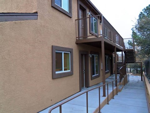 A building with a balcony and stairs leading to it.