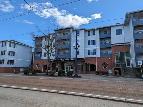 A street view of a building with the words "CITY CENTER APARTMENTS" on it.