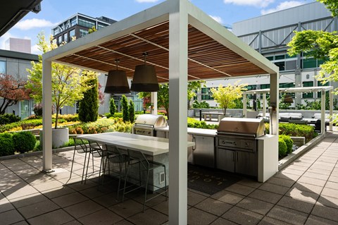 A patio with a table and chairs under a roof.