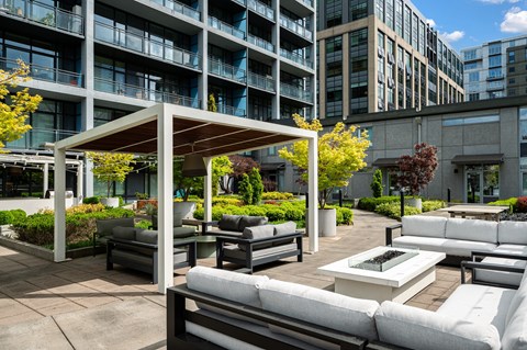 A patio area with white furniture and a canopy.