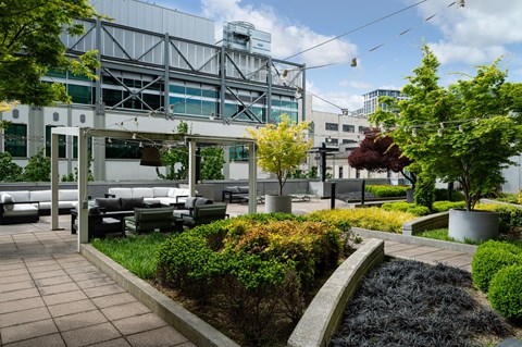 A modern outdoor seating area with a metal structure in the background.