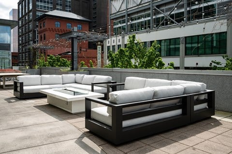 A white couch and table set on a patio.
