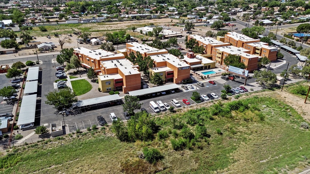 A large building complex with a parking lot in front.