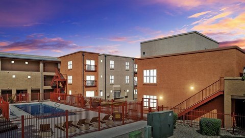 A building with a pool in front of it.