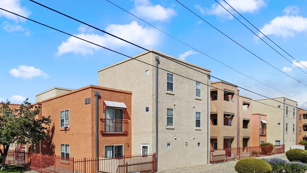 A row of apartment buildings with a clear blue sky above.