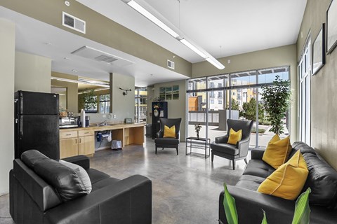 A black couch with yellow pillows sits in a modern living room.