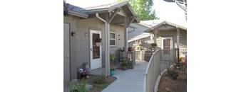 A small building with a white door and a porch.