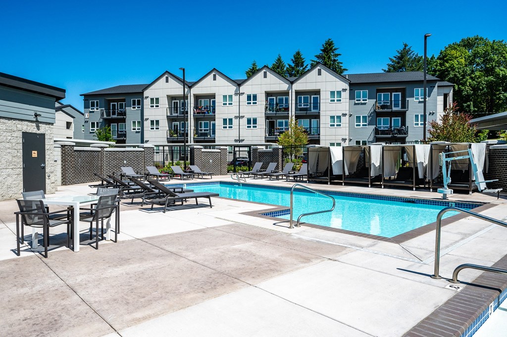 our apartments have a resort style pool with chairs and tables