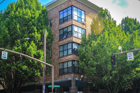 A building with a street sign that says "ONE WAY" is shown.