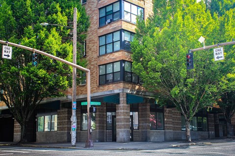 A street view of a building with a one way sign.