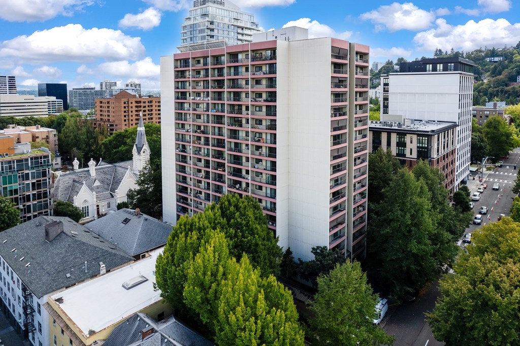 an aerial view of a tall building in a city