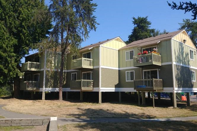 A row of houses with balconies and flower pots.