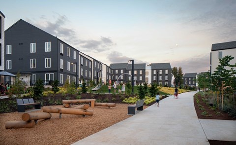 A modern residential area with apartment buildings and a playground.